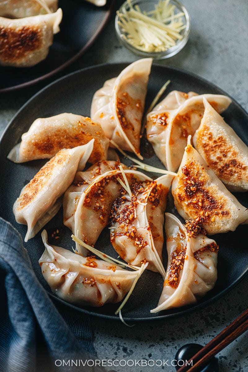 Chinese chicken dumplings served with dipping sauce and chili oil