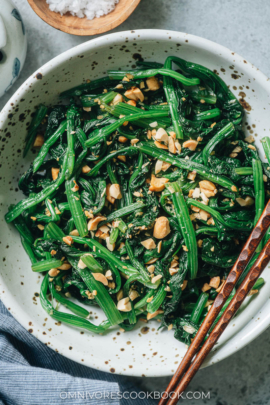 Chinese spinach salad with peanuts close up